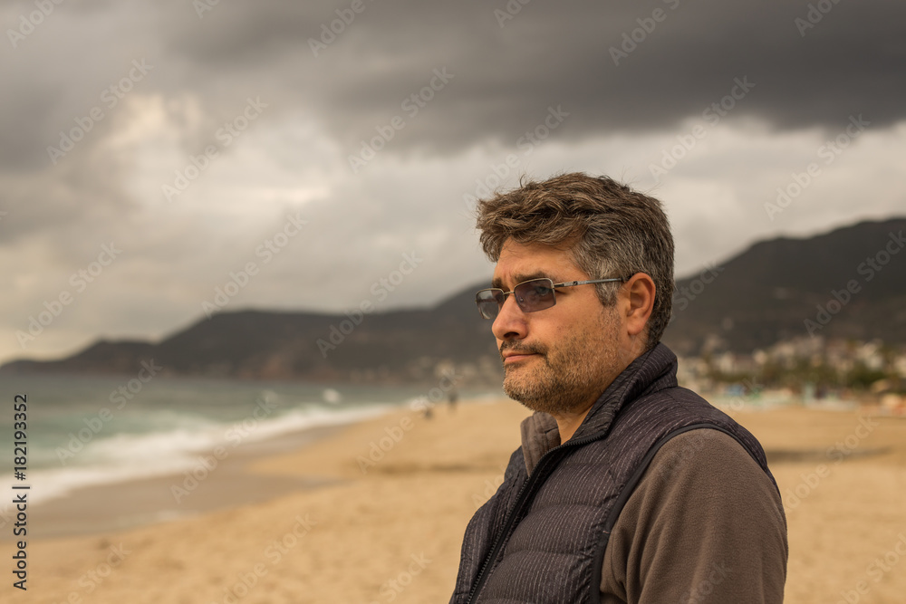 Male thinking at the beach 