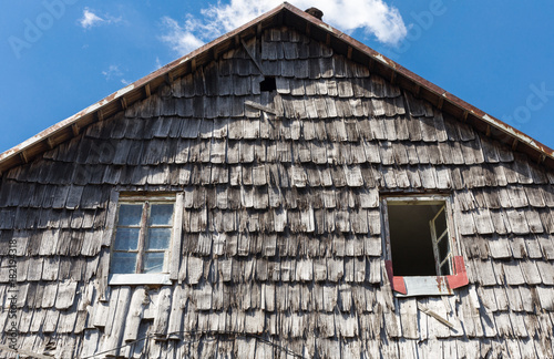 The roof of the wooden tile of the old rural house. Wood roof texture background. photo