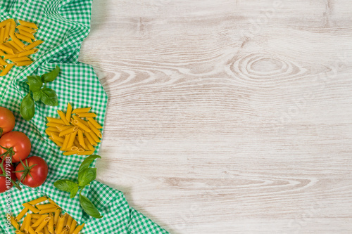 Italian pasta raw ingredients on wooden background.