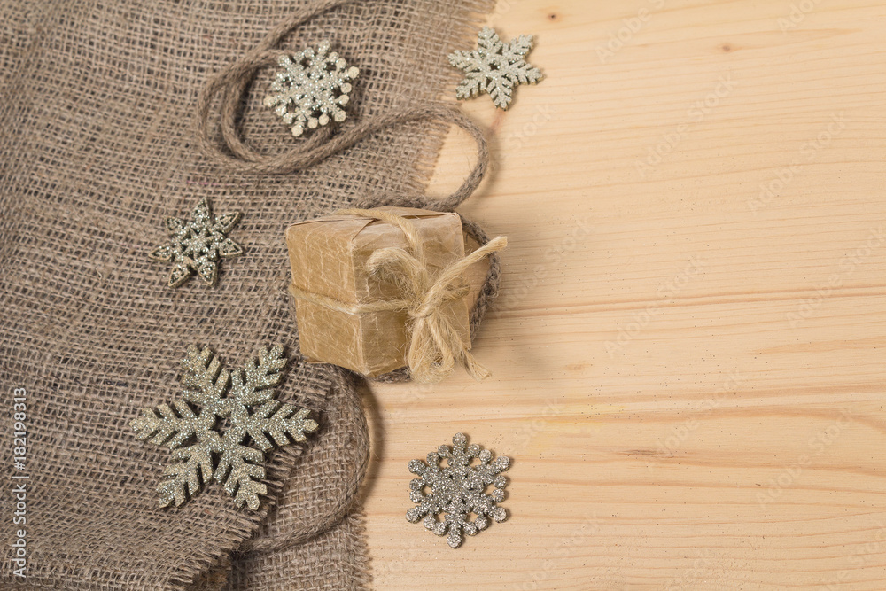 Gift in retro styles and christmas decorations on a wooden surface Gift in retro styles and christmas decorations on a wooden surface