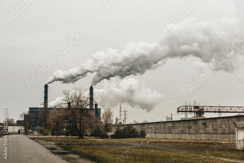 mining enterprise with smoke stacks. Dirty smoke on the sky, ecology problems.