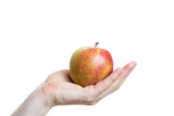 Holding an apple in the palm of a hand on white background