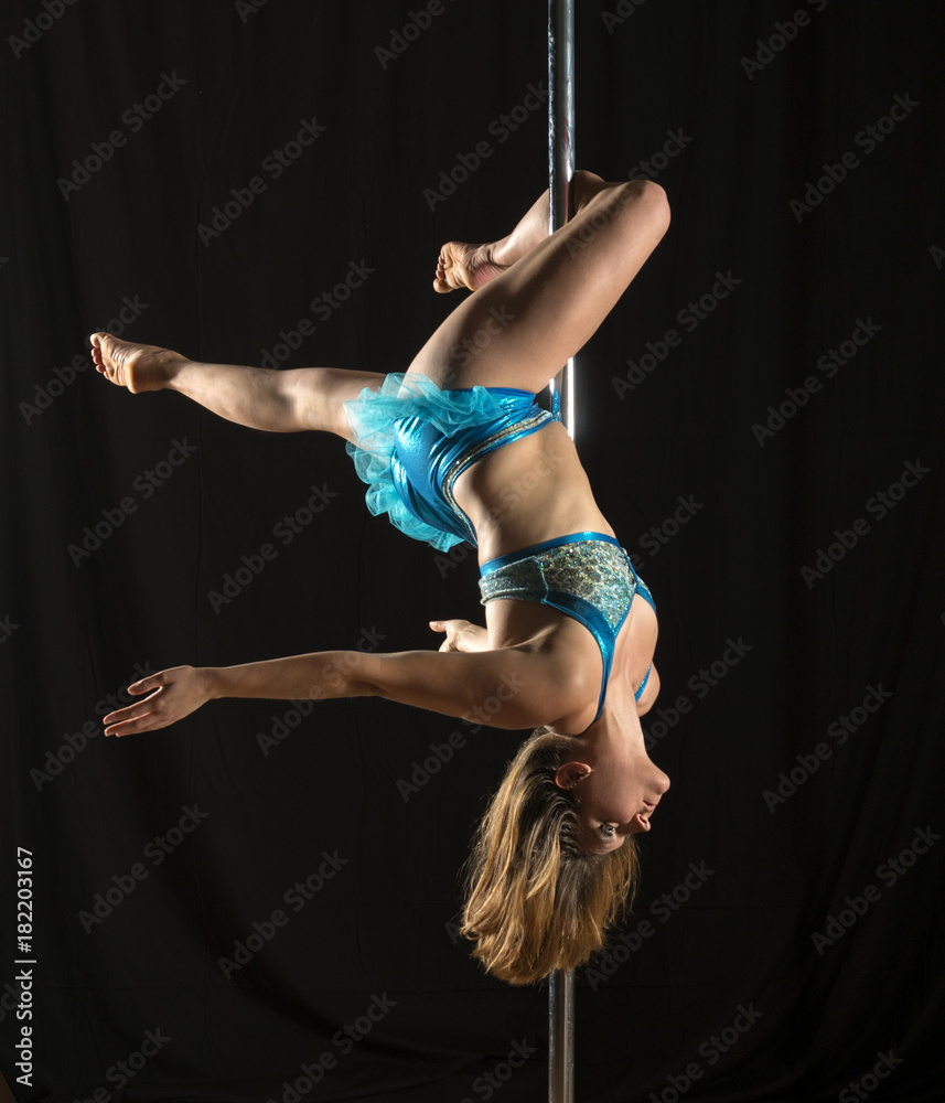 Young woman in pole fitness performance-outside leg hang Stock Photo |  Adobe Stock