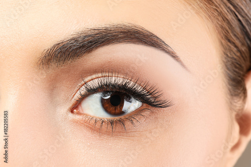 Beautiful young woman with eyelash extensions, closeup