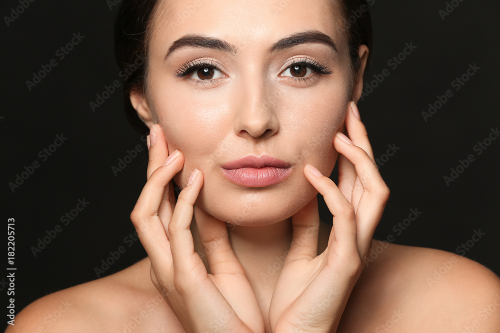 Beautiful young woman with eyelash extensions on dark background Beautiful young woman with eyelash extensions on dark background