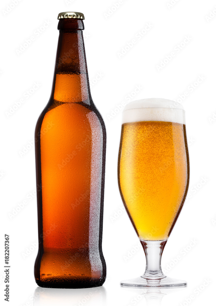Cold bottle and glass of lager beer with foam