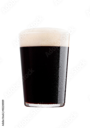 Cold glass of dark beer with foam and dew