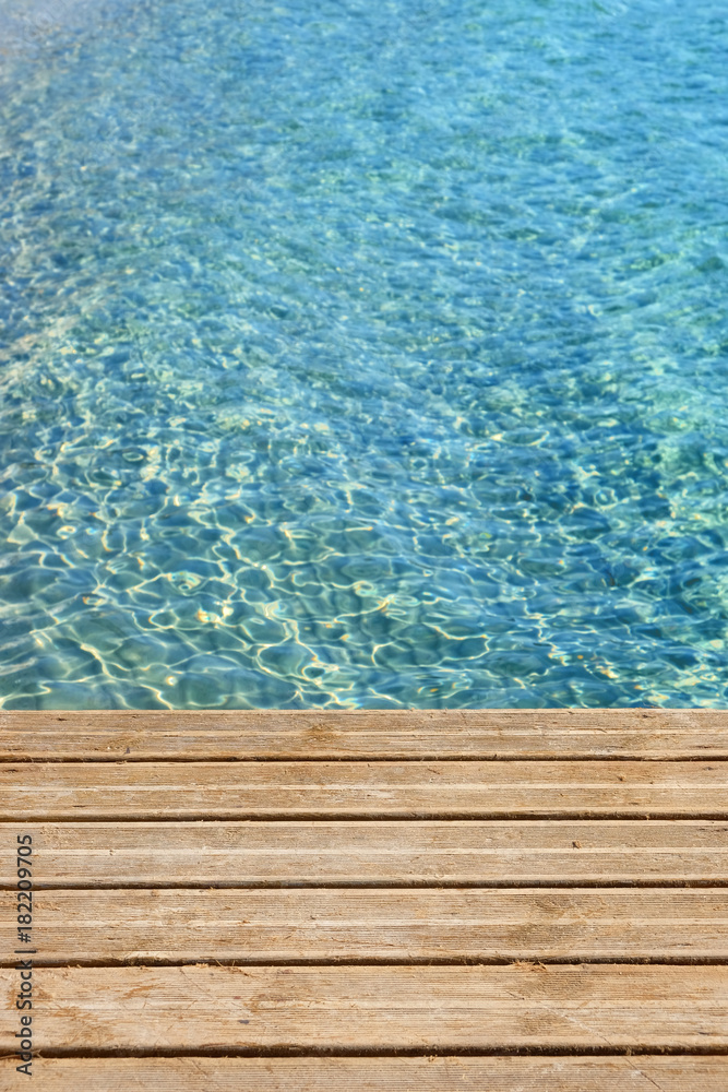 Caribbean sea with wood wooden jetty and clear blue sea photo vertical