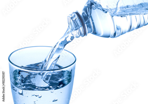 Pouring water on a glass isolated on white background. Clipping path