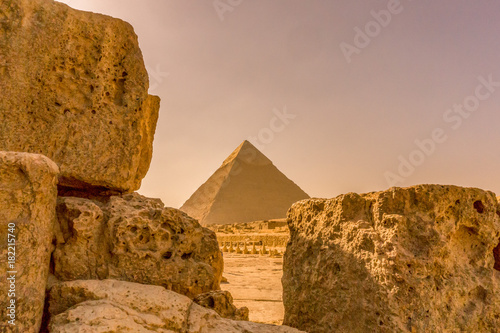Pyramid in Giza framed between limestone blocks