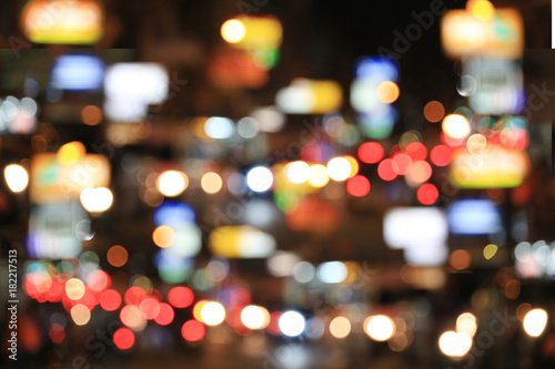 Blurry background of road with roaming cars at night. © meepoohyaphoto