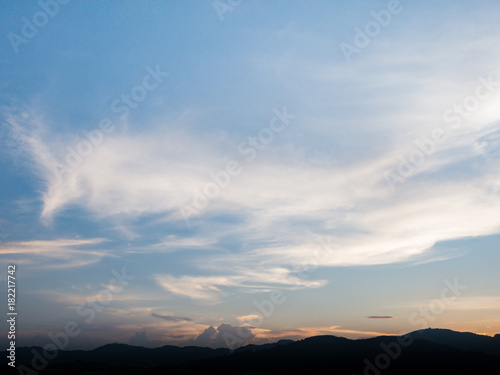 the beautiful blue sky with cloudy background and silhouette mountain in the evening