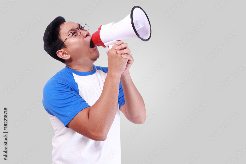 Young Man Shouting with Megaphone, Promotion Concept Young Man Shouting with Megaphone, Promotion Concept