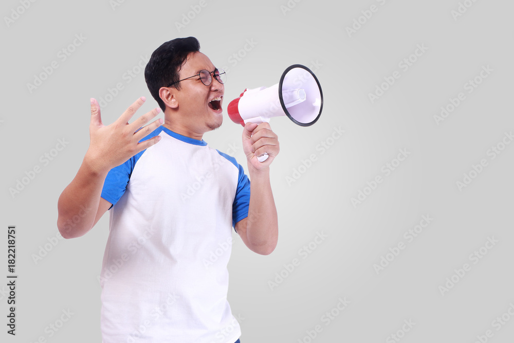 Young Man Shouting with Megaphone, Promotion Concept Young Man Shouting with Megaphone, Promotion Concept