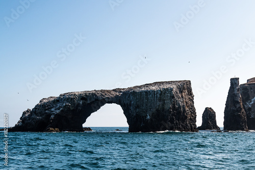 Arch Rock natural bridge and other nearby volcanic rock formations at East Anacapa Island in Channel Islands National Park off the coast from Ventura, California. photo