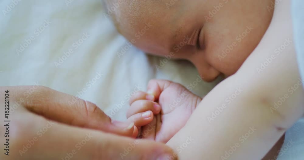 Mother comforting cute little baby as he falls asleep Mother comforting cute little baby as he falls asleep