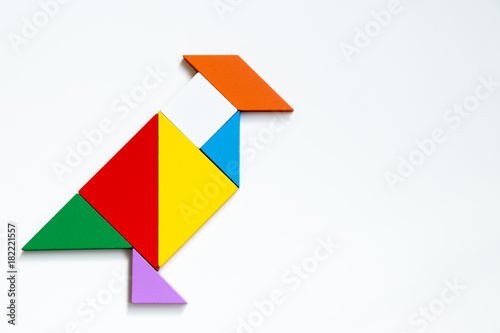 Colorful wood tangram puzzle in bird shape on white background