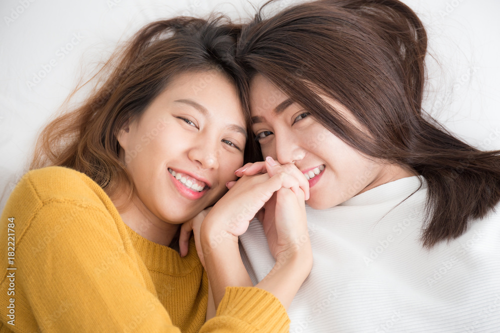 Couple of young asian women on white bed with happiness moment,lesbian couple concept
