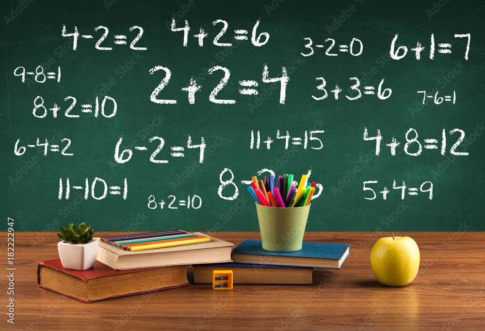 School blackboard with pile of books School blackboard with pile of books