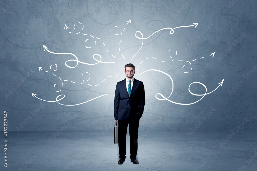 Businessman standing with winding arrows around Businessman standing with winding arrows around