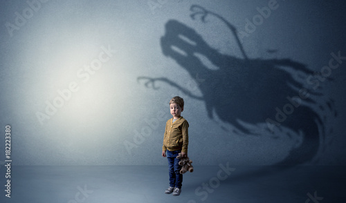 Scary ghost shadow behind kid © ra2 studio