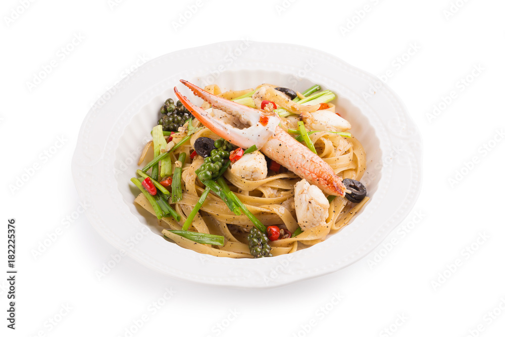Spicy Seafood Spaghetti on a white ceramic dish isolated on white background Spicy Seafood Spaghetti on a white ceramic dish isolated on white background