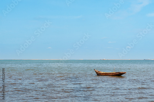 One lonely wooden fishing boat in sea