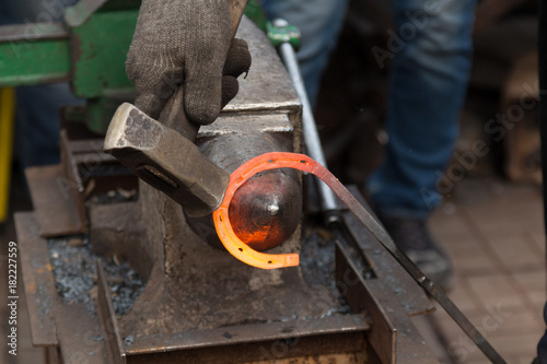 Making the horseshoe from heated red rod