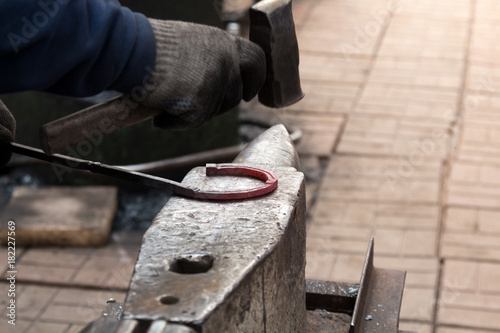Making the horseshoe from heated red rod