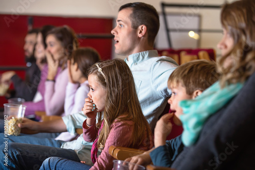 Number of people enjoying film screening and popcorn