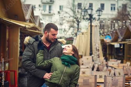 Young loving couple on a city street . Romantic couple in autumn city walk