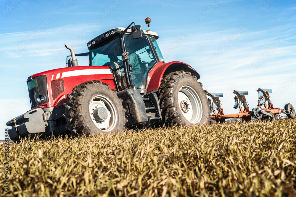 Fototapeta premium Close up of tractor machine in the field. Agriculture cultivation machinery.
