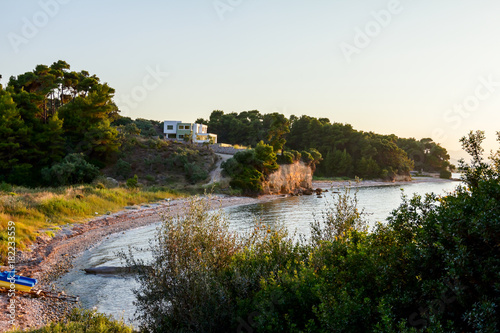 House on cliff above seashore