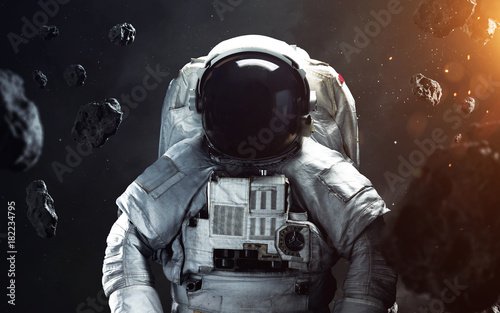 Fototapeta Naklejka Na Ścianę i Meble -  Brave astronaut at the spacewalk. People in space. Elements of this image furnished by NASA