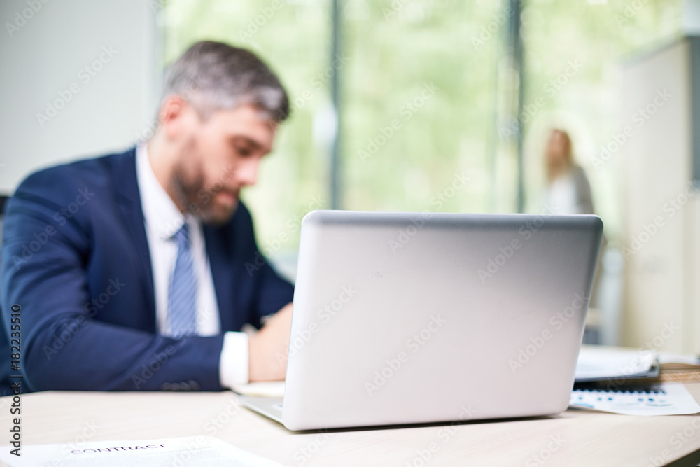 custom made wallpaper toronto digitalBusy open plan office: confident middle-aged manager wrapped up in work sitting at desk while his female colleague standing at panoramic window