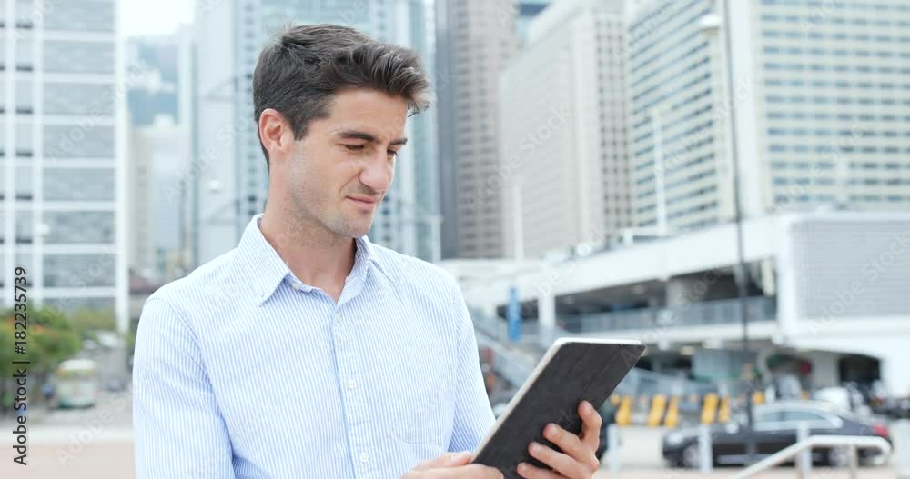 Caucasian business man use of tablet at outdoor Caucasian business man use of tablet at outdoor