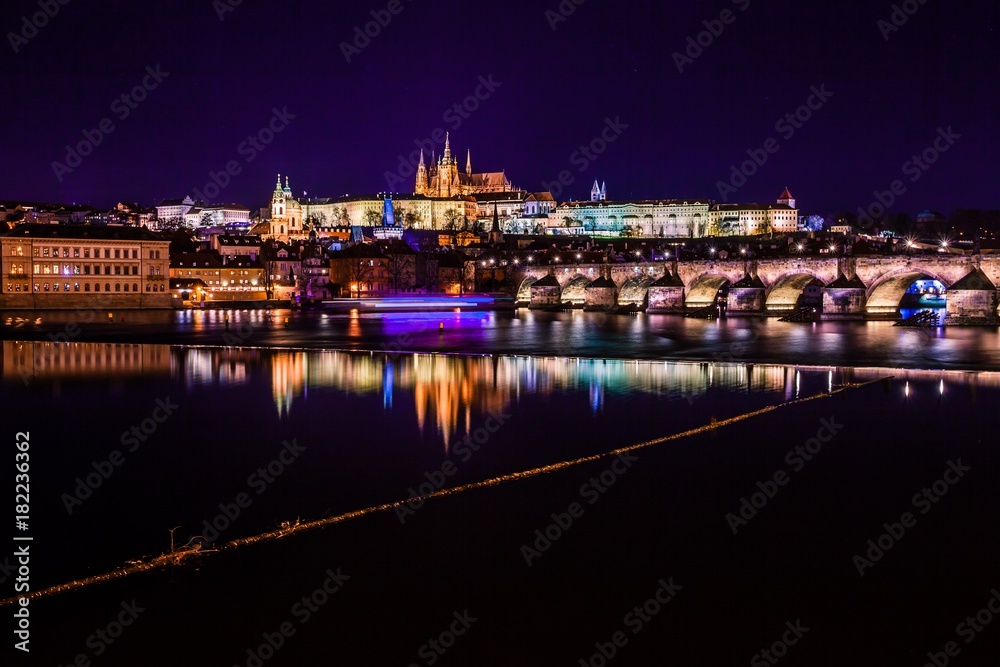 The view from the river Vltava at Charles Bridge and Prague Castle at night