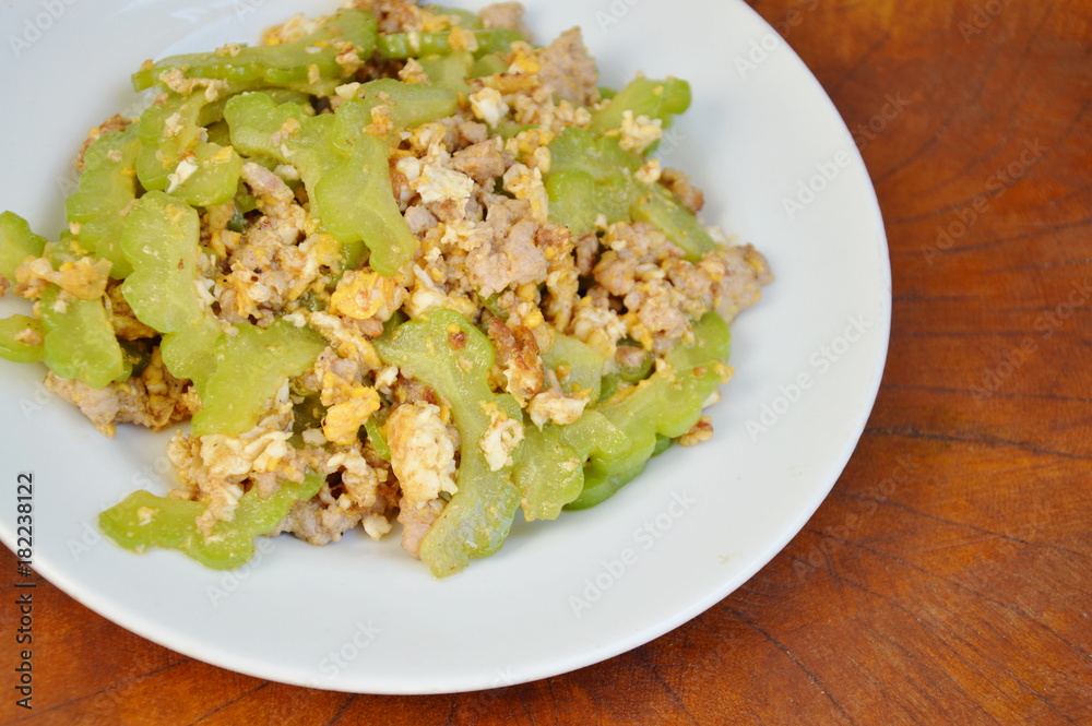 stir fried bitter cucumber with minced pork and egg on plate stir fried bitter cucumber with minced pork and egg on plate