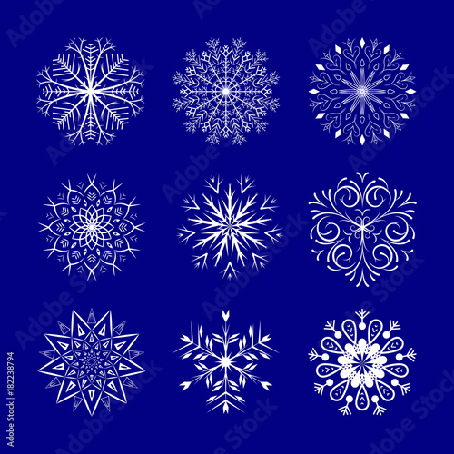 Snowflakes set on blue background. Winter Holidays Decorative design elements.