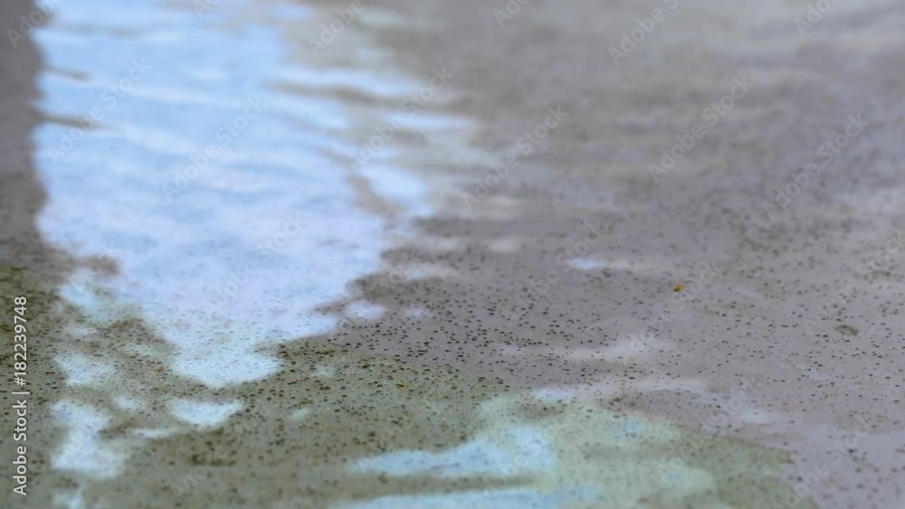 A macro shot of a water puddle on the floor. A macro shot of a water puddle on the floor.