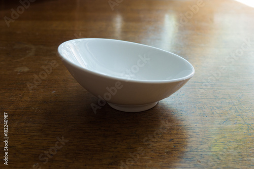 Slighly skew empty white ceramic sauce boat