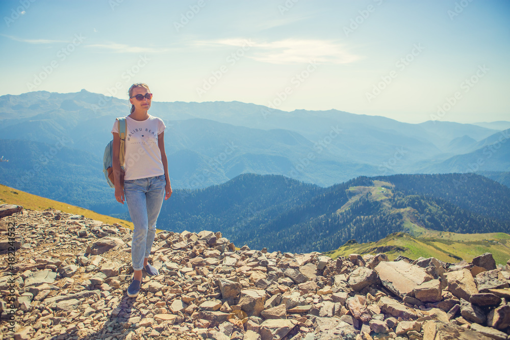 Happy woman traveler in the mountains and the landscape of mountains and blue sky Travel lifestyle concept of adventure summer holidays.