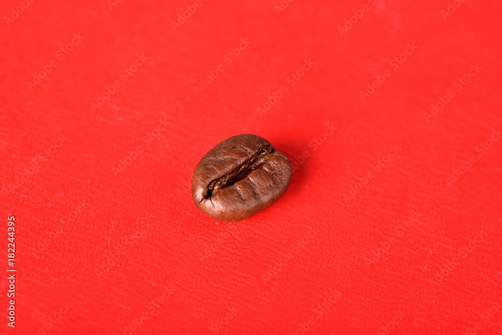 Texture of grains of caffeine.Place for text.Roasted coffee beans.Advertising for coffee.Coffee beans on a red background. Texture of grains of caffeine.Place for text.Roasted coffee beans.Advertising for coffee.Coffee beans on a red background.