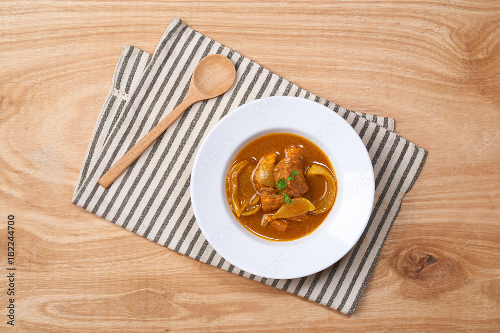 curry chicken with sauce on white dish