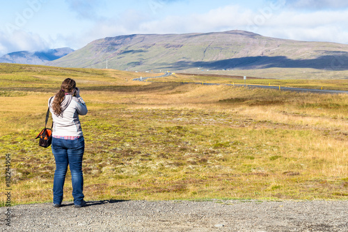 the tourist photographs a landscape in Iceland