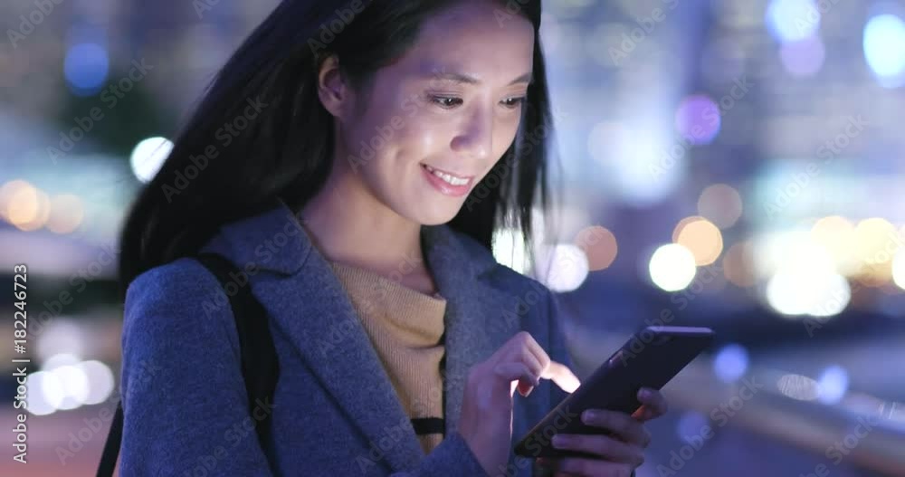 Woman use of mobile phone in city at night Woman use of mobile phone in city at night