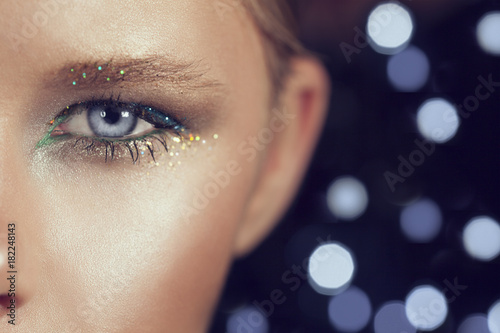 Wallpaper Mural painted eyelashes of a young girl. macro photo girl eye makeup in glitter Torontodigital.ca