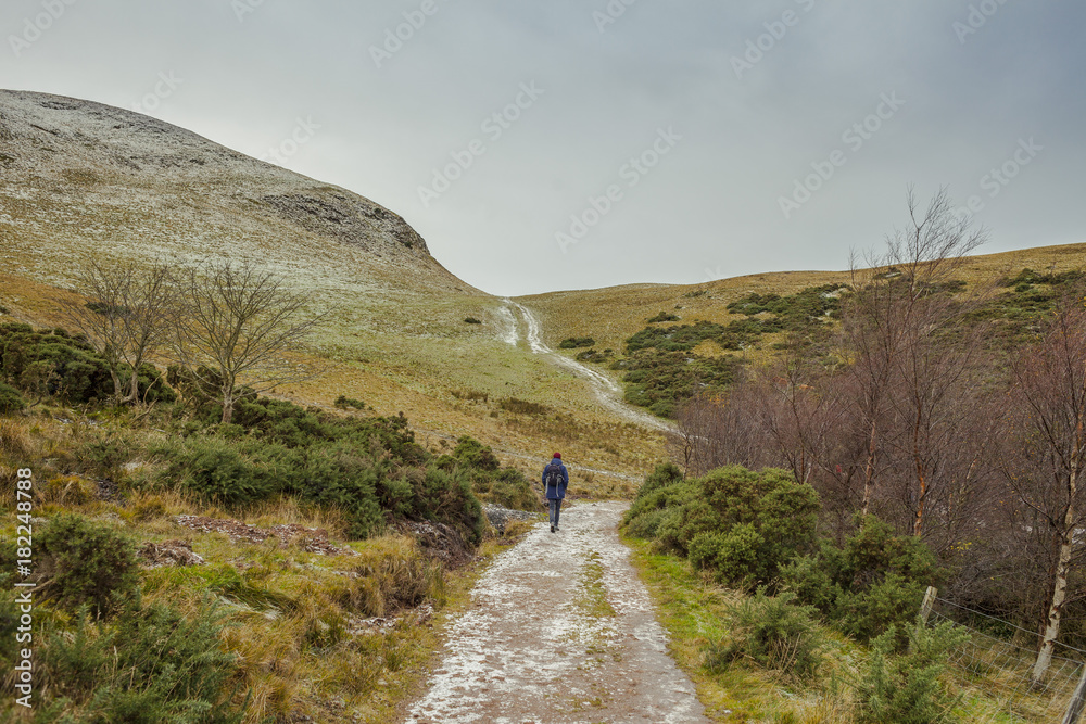 A man walking in Scotland wilderness