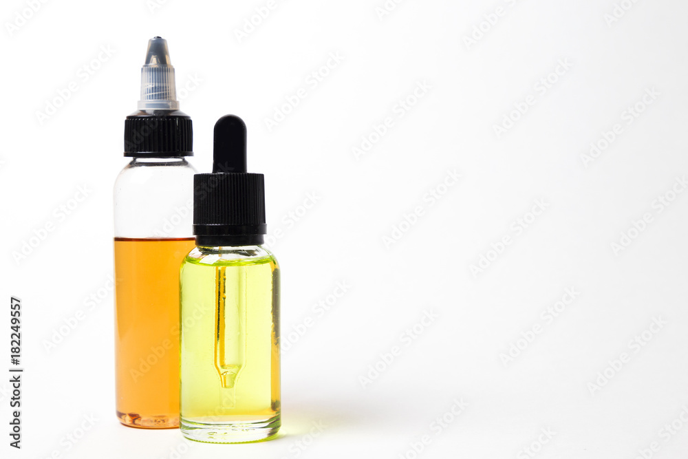 e- liquid, e-juice in the bottles isolated on the white background with copyspace