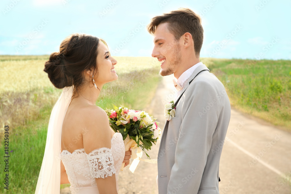 Happy beautiful couple on wedding day, outdoors